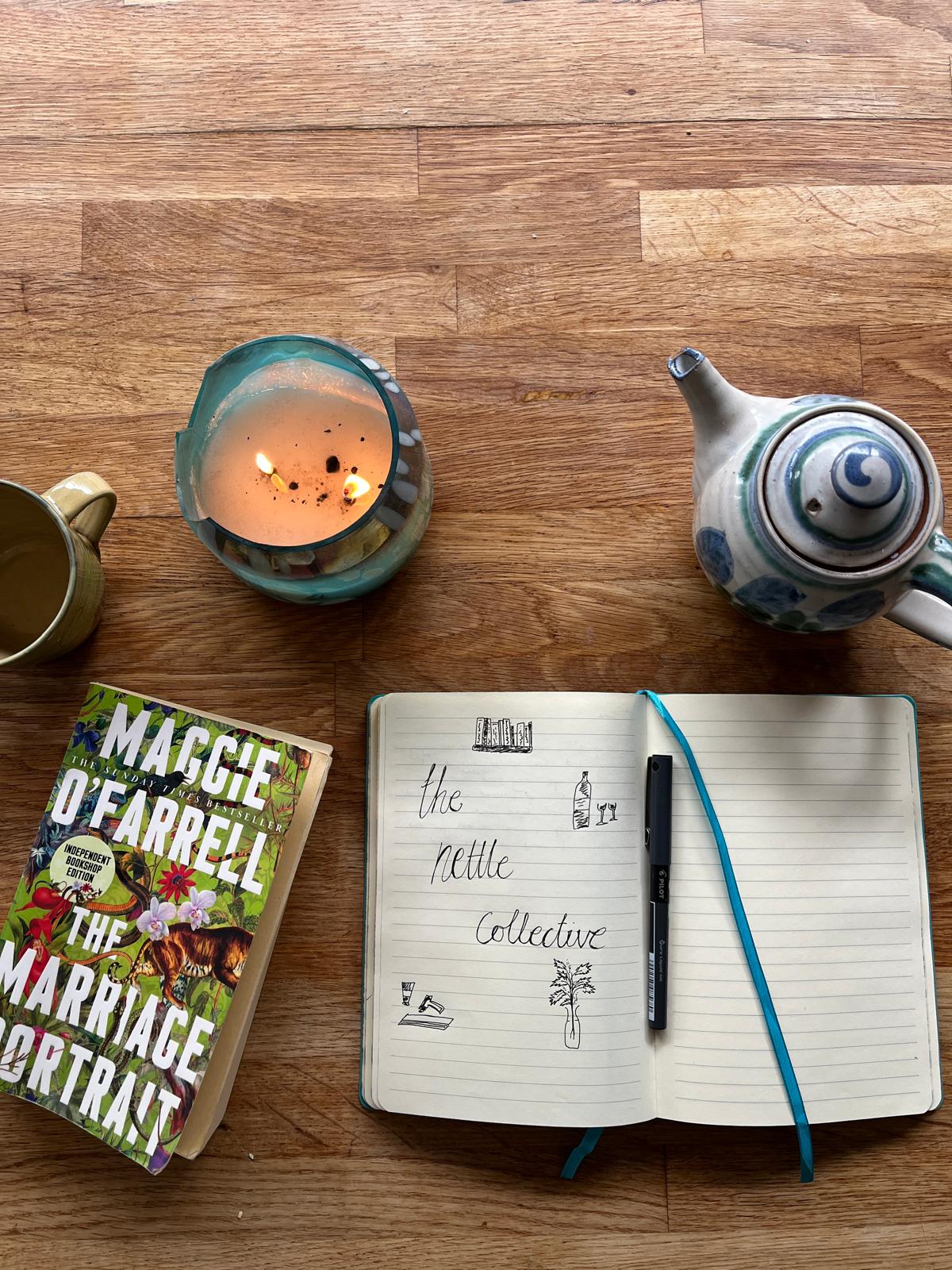 The Nettle Collective journal with candle, teapot and The Marriage Portrait book